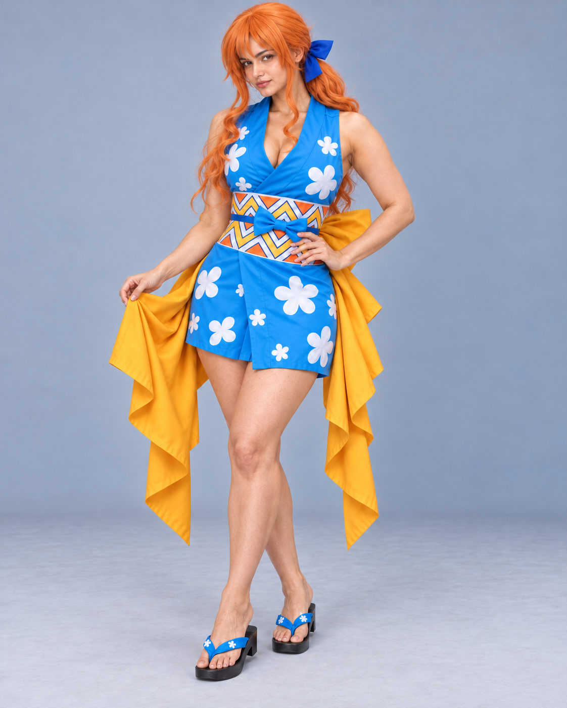 Nami Onigashima cosplay standing view showing crossover neckline, floral print, patterned waistband and yellow panels.