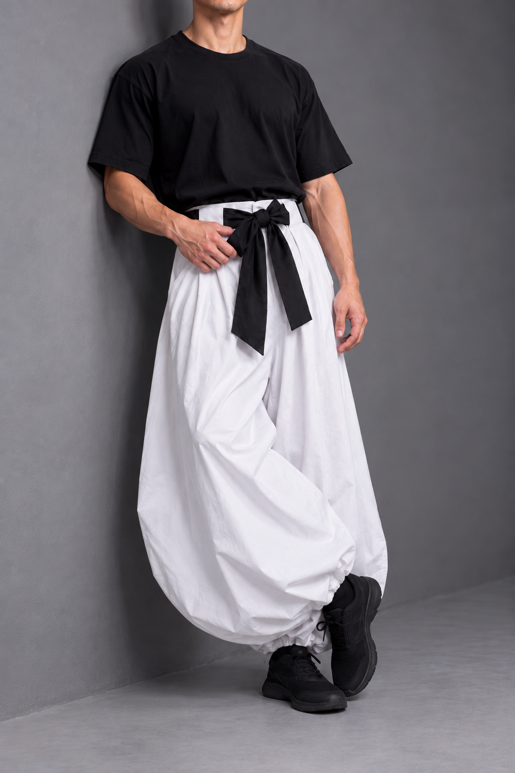 Toji inspired cosplay black tee white trousers wall pose